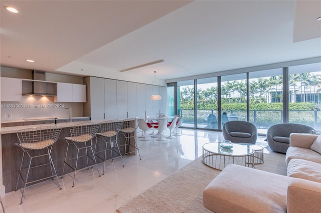 living room with light tile flooring and expansive windows