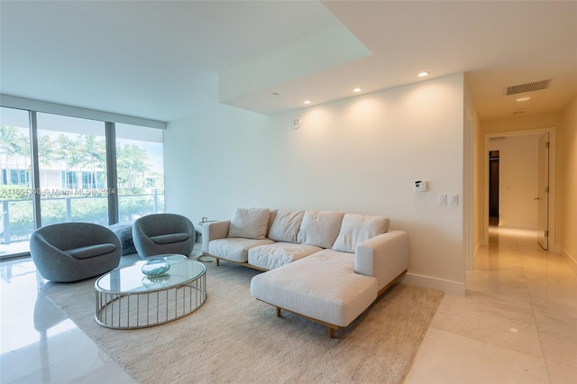 tiled living room featuring expansive windows