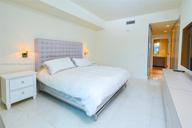 tiled bedroom featuring ensuite bathroom