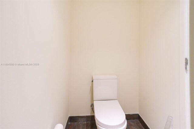 bathroom featuring tile floors and toilet