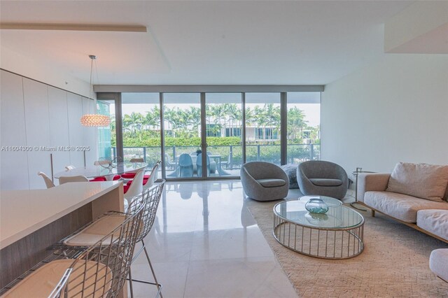 tiled living room featuring a wall of windows