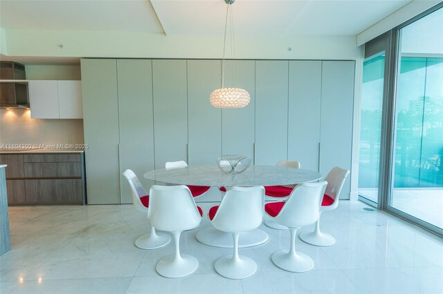 dining area featuring floor to ceiling windows and light tile floors