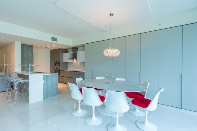 tiled dining room featuring sink