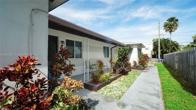 view of property exterior with fence and stucco siding