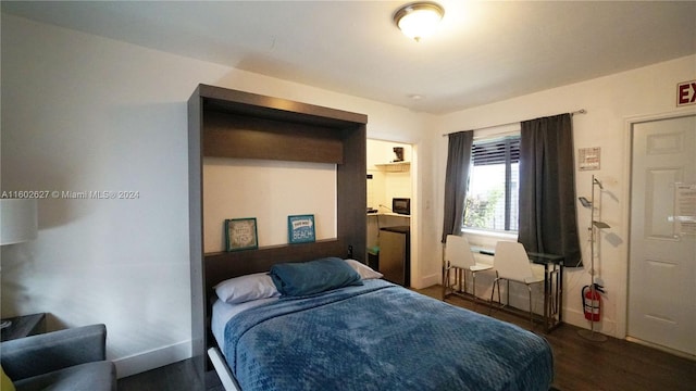 bedroom featuring dark wood-style flooring and baseboards