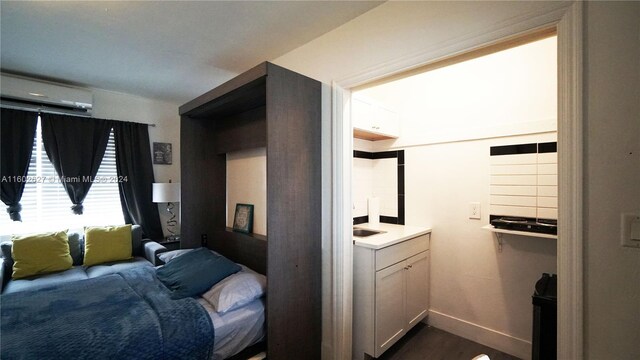 bedroom with dark wood-type flooring and a wall mounted air conditioner