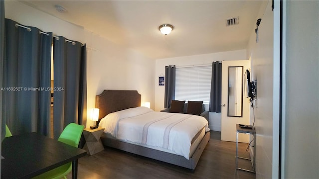 bedroom featuring dark wood-type flooring and visible vents