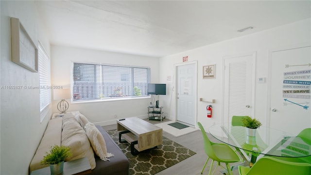 living room featuring baseboards and visible vents