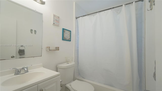 bathroom with toilet, shower / tub combo, and vanity