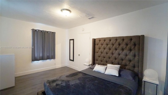 unfurnished bedroom with dark wood-type flooring