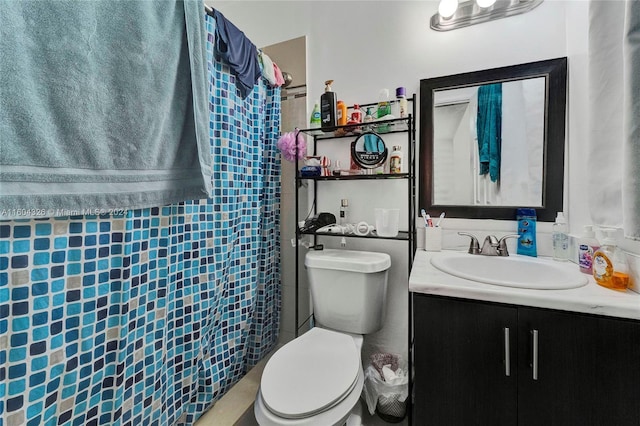 bathroom featuring vanity, toilet, and walk in shower