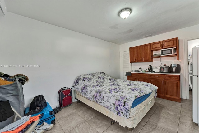 tiled bedroom with white fridge