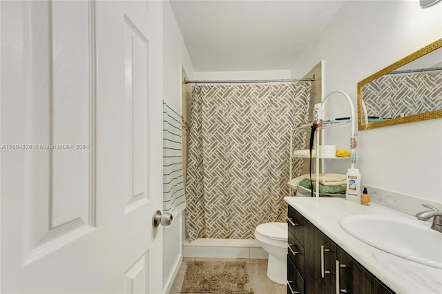 bathroom featuring tile patterned floors, toilet, curtained shower, and vanity