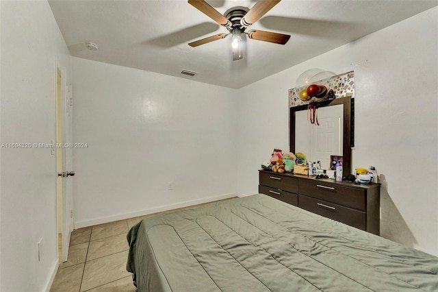 tiled bedroom with ceiling fan