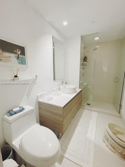 bathroom featuring tile patterned floors, vanity, toilet, and walk in shower