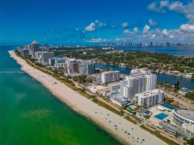 drone / aerial view featuring a view of the beach and a water view