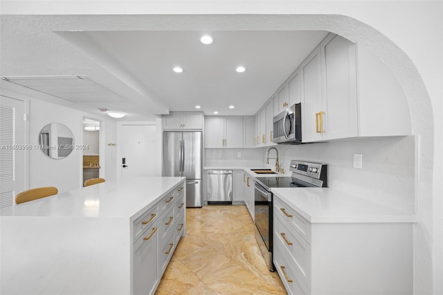 kitchen featuring white cabinetry, sink, and stainless steel appliances