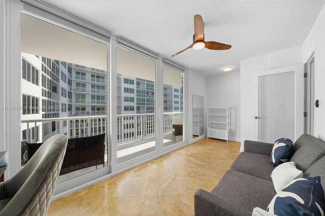 living room featuring ceiling fan and floor to ceiling windows