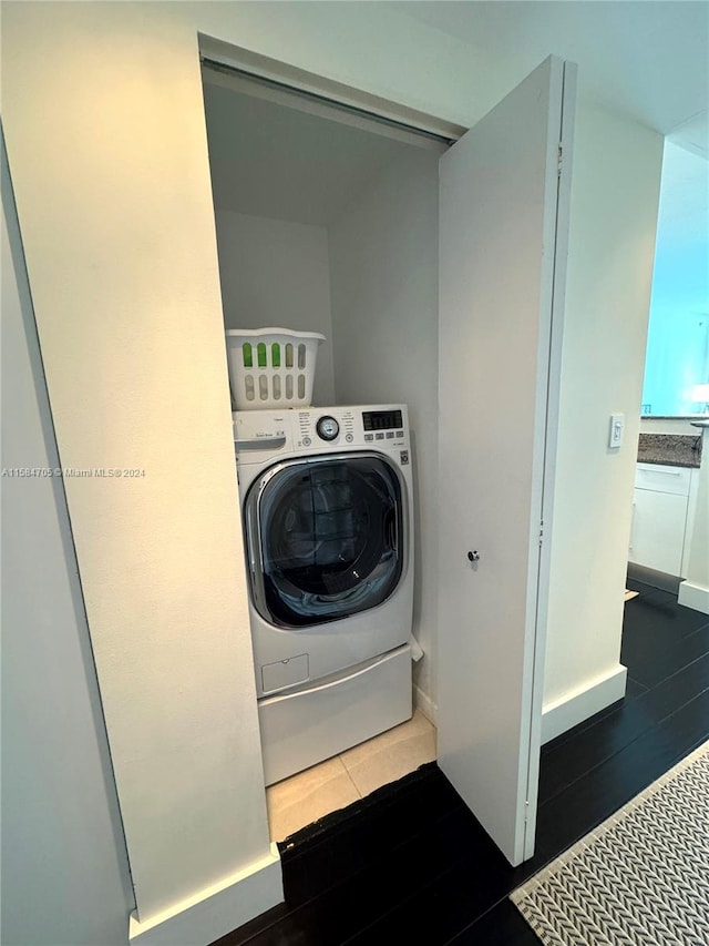 clothes washing area featuring washer / dryer and dark wood-type flooring