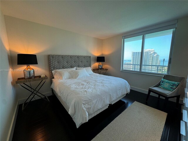 bedroom with dark wood-type flooring