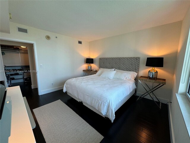 bedroom featuring dark wood-type flooring