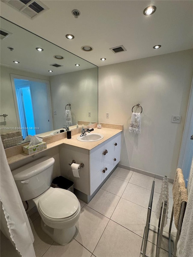 bathroom featuring tile patterned floors, toilet, and vanity