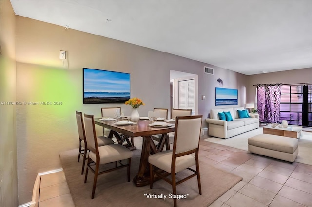 dining area featuring light tile patterned floors