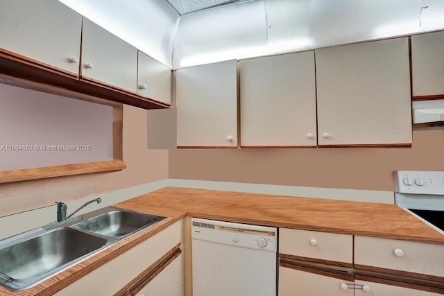 kitchen featuring stove, white dishwasher, sink, white cabinetry, and range hood