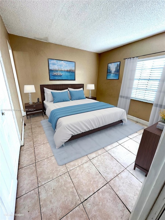 tiled bedroom with a textured ceiling