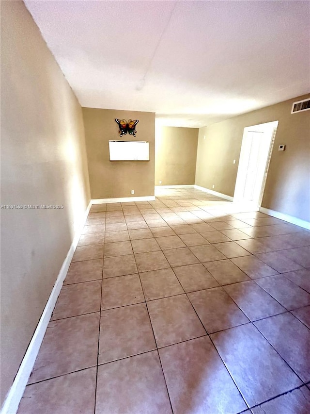 empty room featuring tile patterned floors