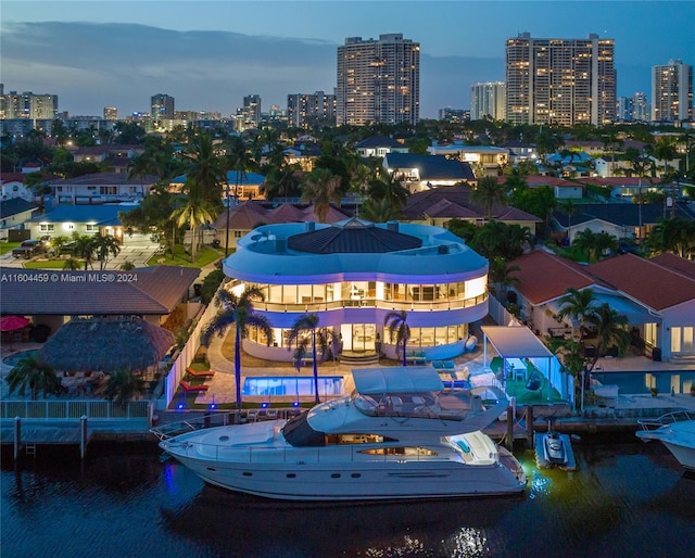 aerial view at dusk featuring a water view