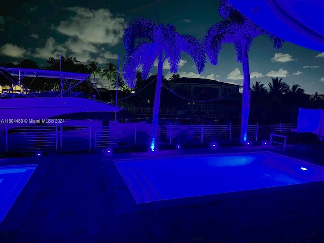 view of pool at dusk