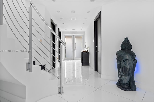 hall featuring french doors and light tile patterned floors