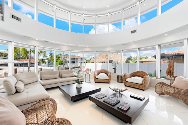 3344 NE 167th St, North Miami Beach, FL 33160 - tiled living room with healthy amount of natural light, a high ceiling, and recessed lighting