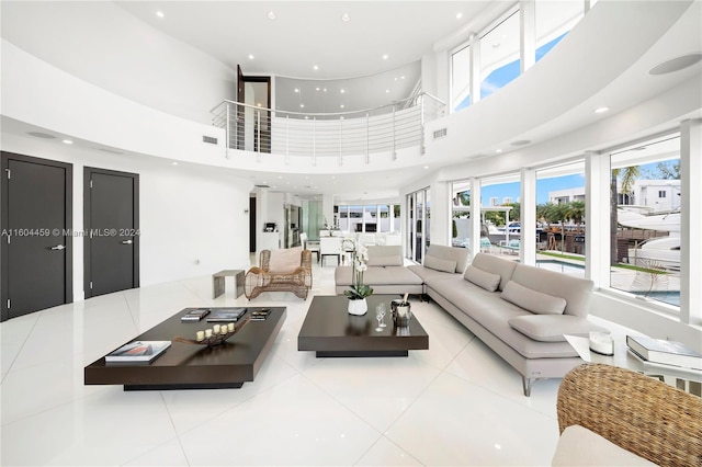 living room with light tile patterned floors and a high ceiling