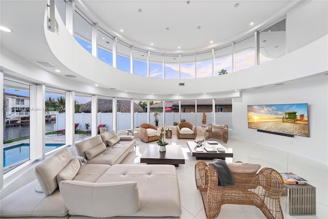 living room featuring light tile patterned flooring and a high ceiling