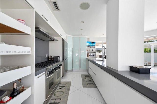 3344 NE 167th St, North Miami Beach, FL 33160 - kitchen featuring stainless steel appliances, dark countertops, white cabinetry, and modern cabinets