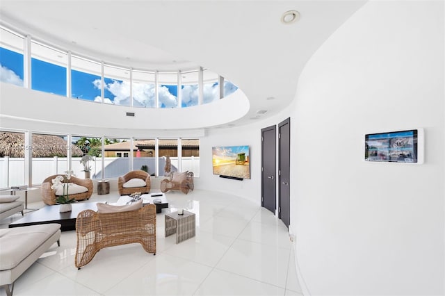 3344 NE 167th St, North Miami Beach, FL 33160 - living area featuring a high ceiling, light tile patterned floors, and recessed lighting