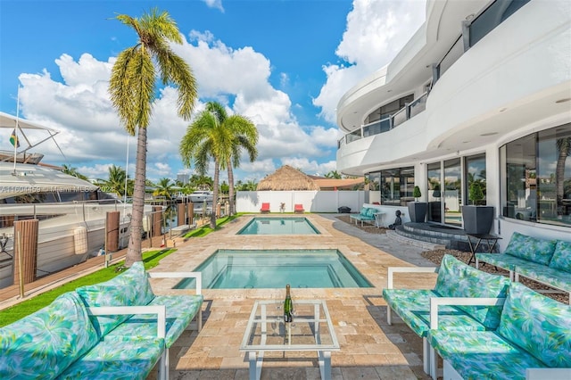 3344 NE 167th St, North Miami Beach, FL 33160 - view of swimming pool featuring a patio, an in-ground hot tub, and a fenced backyard