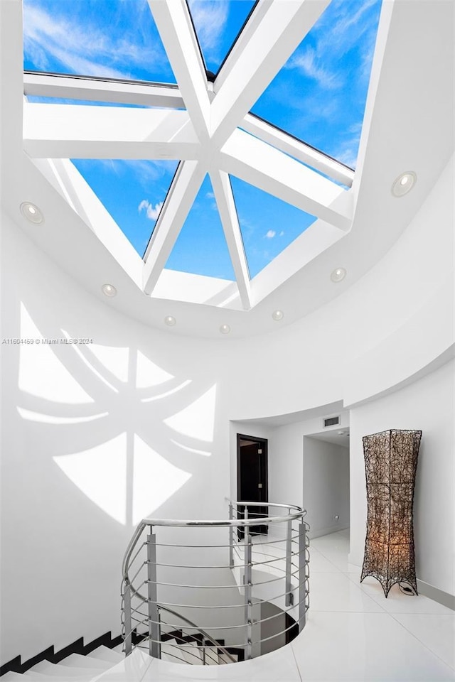 3344 NE 167th St, North Miami Beach, FL 33160 - stairway featuring recessed lighting, a towering ceiling, and tile patterned floors