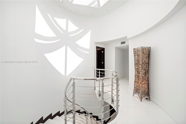 3344 NE 167th St, North Miami Beach, FL 33160 - hallway featuring an upstairs landing and light tile patterned floors