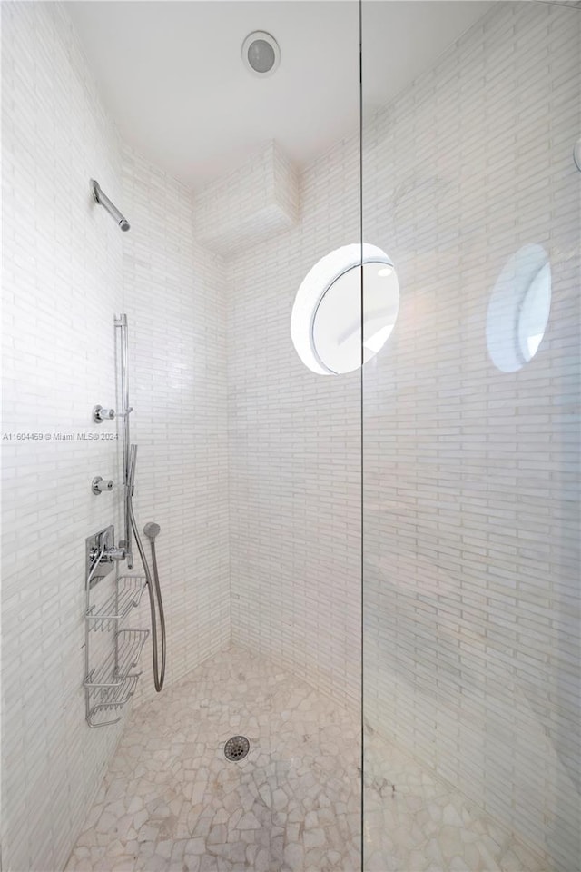 bathroom with a tile shower