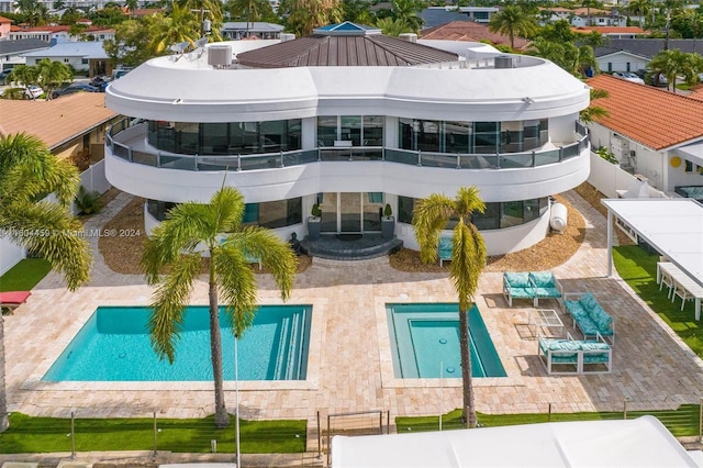 back of house featuring a balcony and a patio