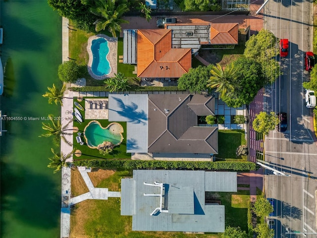 birds eye view of property with a water view