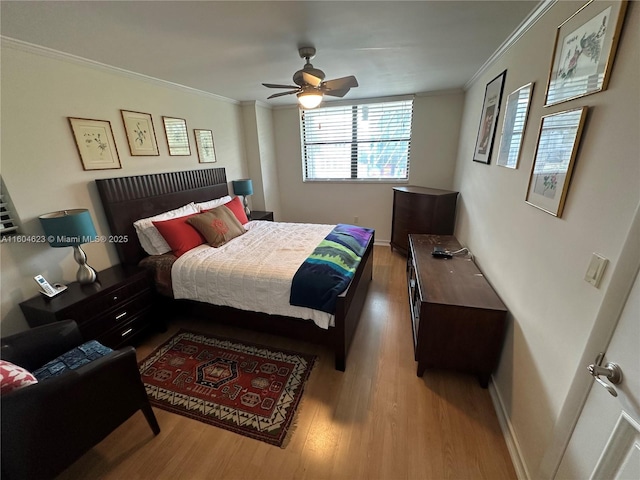 bedroom with ceiling fan, light hardwood / wood-style floors, and crown molding