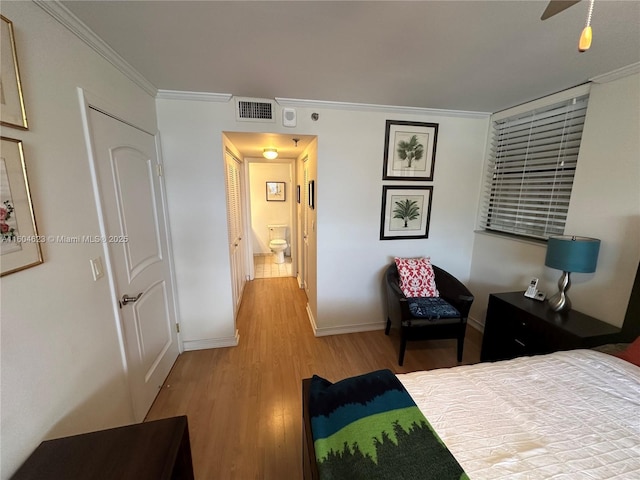 bedroom with hardwood / wood-style floors and ornamental molding