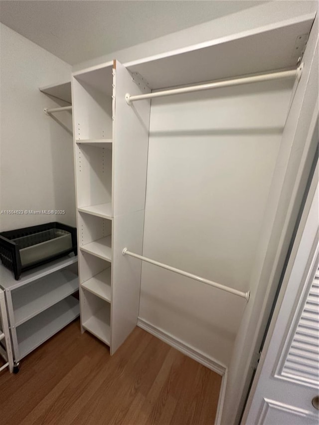 spacious closet featuring hardwood / wood-style flooring