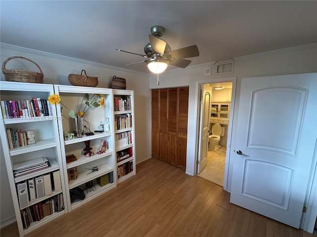 interior space with light hardwood / wood-style floors, ornamental molding, and ceiling fan