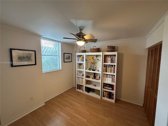 interior space featuring ceiling fan, crown molding, and light hardwood / wood-style flooring