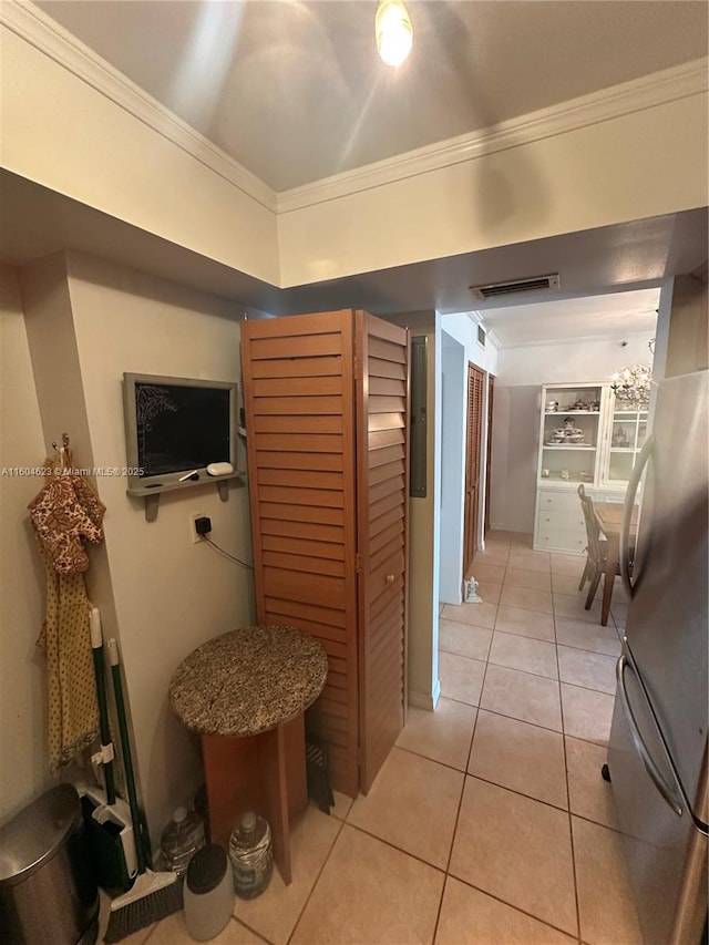 corridor featuring light tile patterned flooring, crown molding, and electric panel